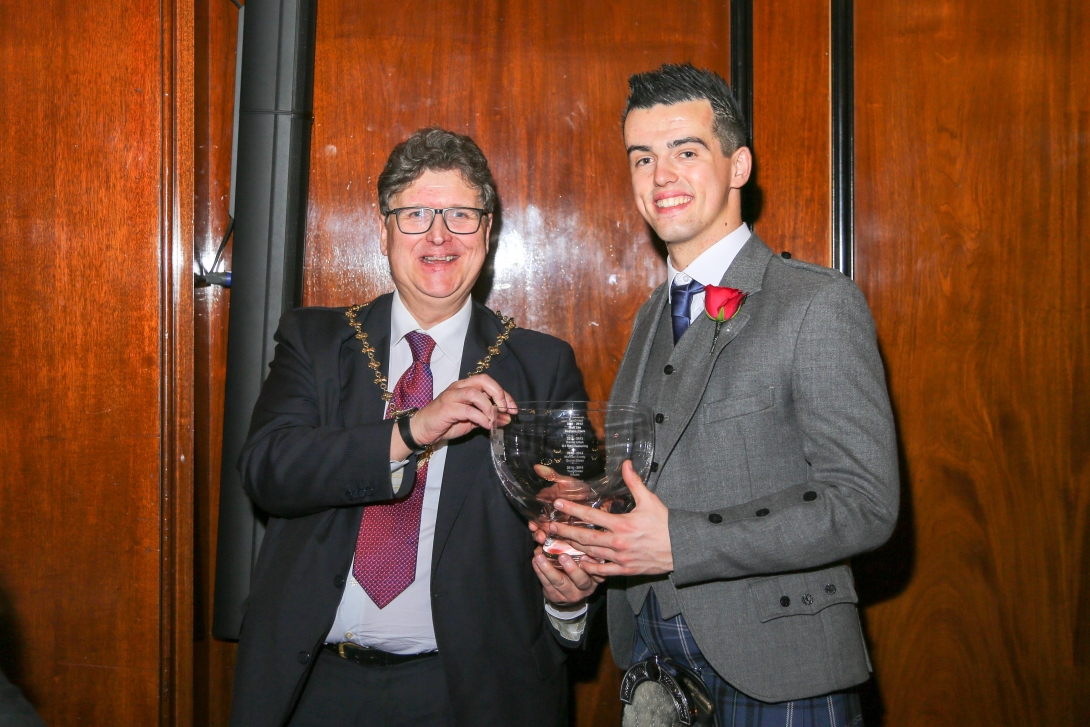 Apprentice of the Year Gareth Owen receives an engraved rose bowl from Master of the Glass Sellers Leigh Baildham 